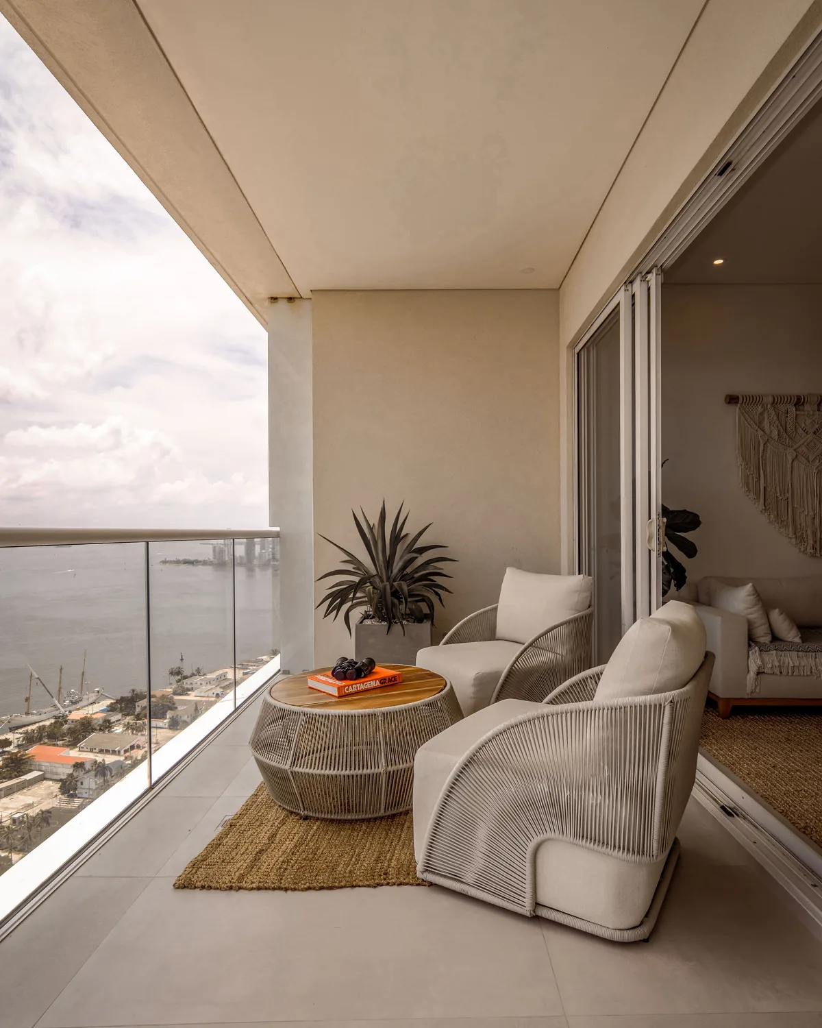 Coastal balcony with seating and a water view.